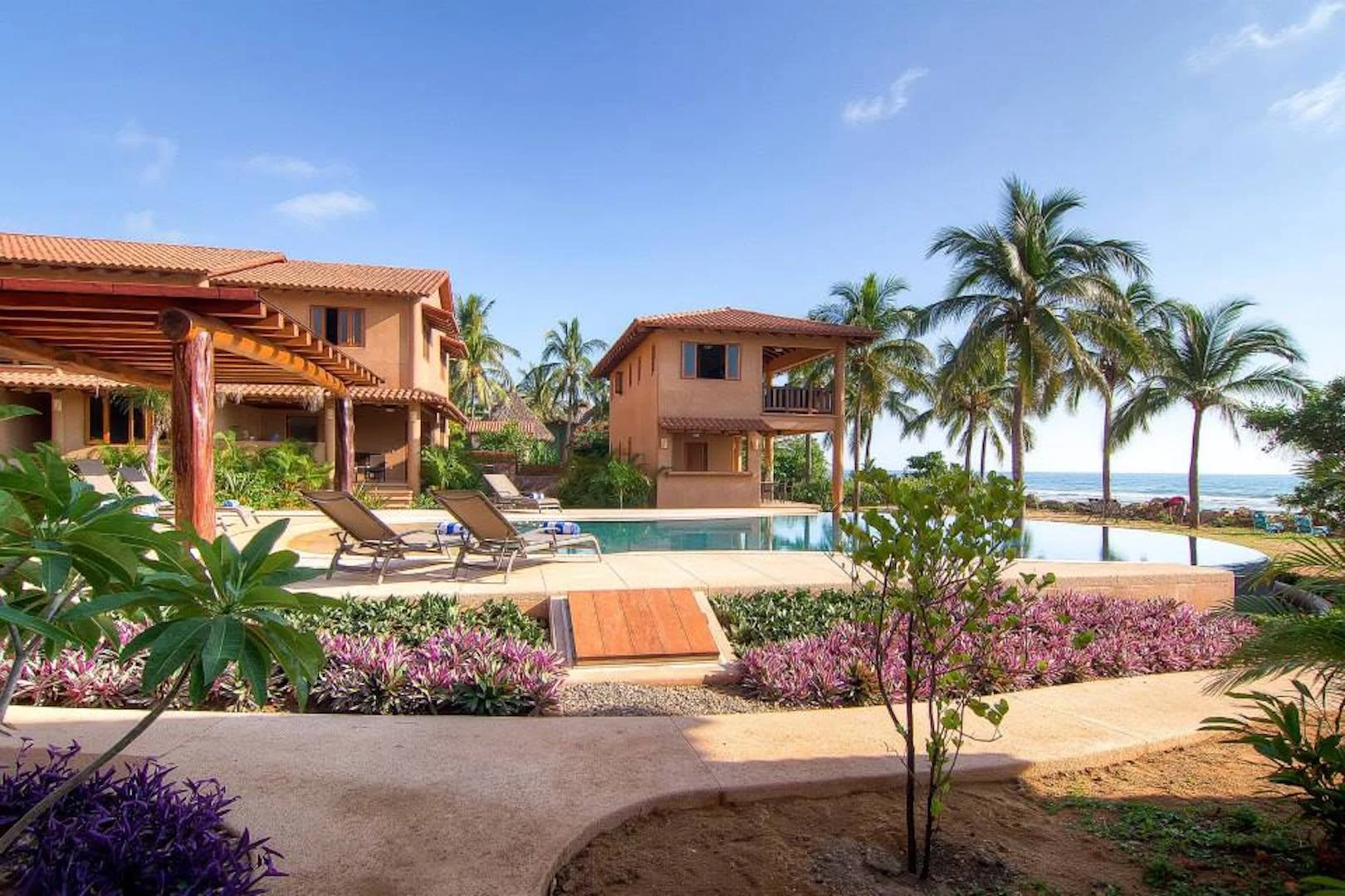 Tropical gardens, pool and beachfront setting